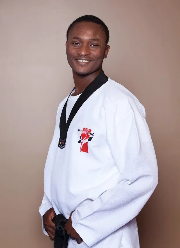 smiling-taekwondo-instructor-black-belt-white-dobok