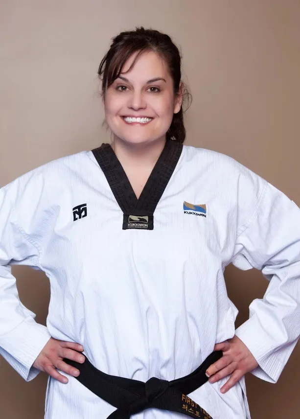 smiling-woman-in-taekwondo-uniform-with-black-belt