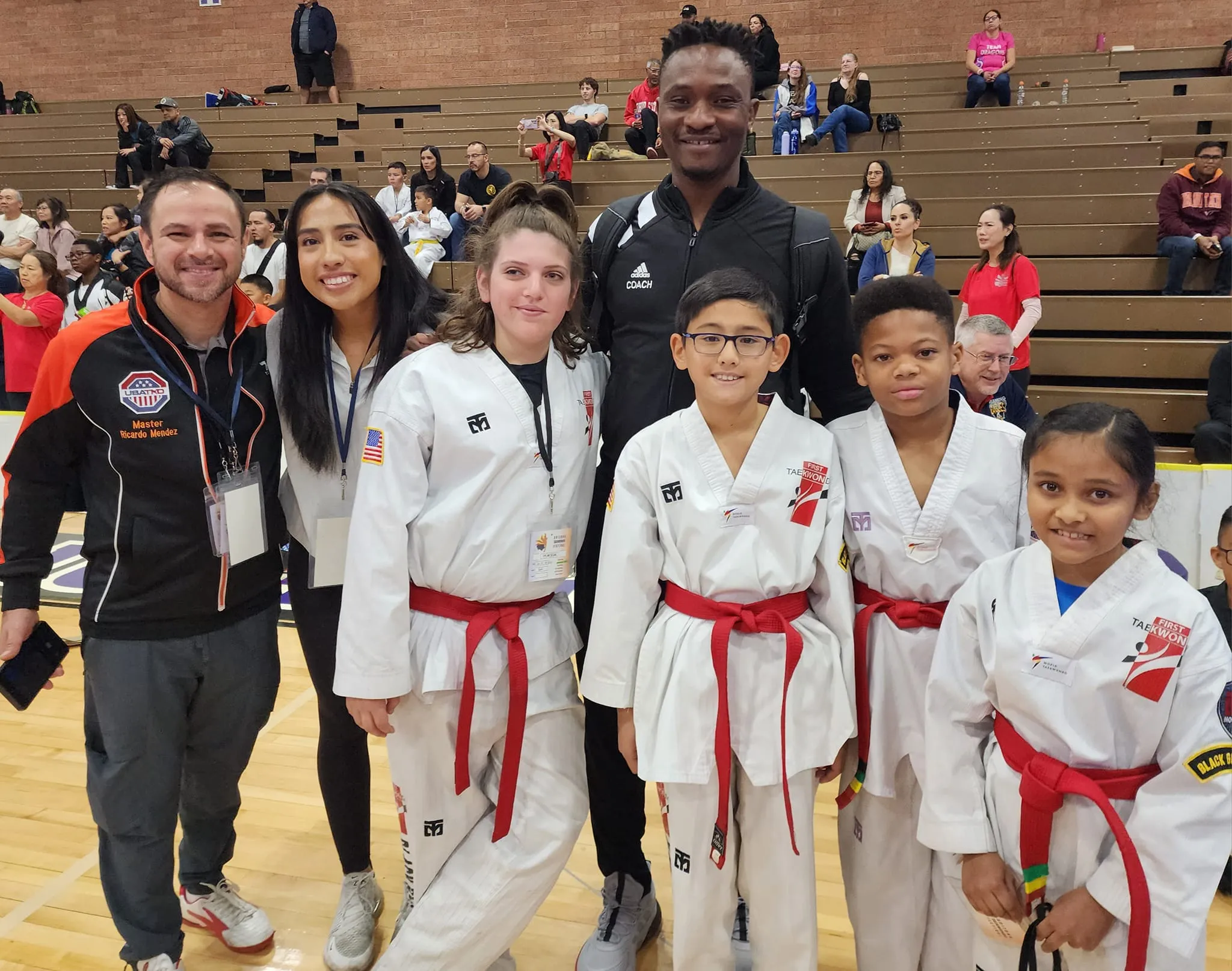 taekwondo-instructors-and-young-students-smiling-together-at-event